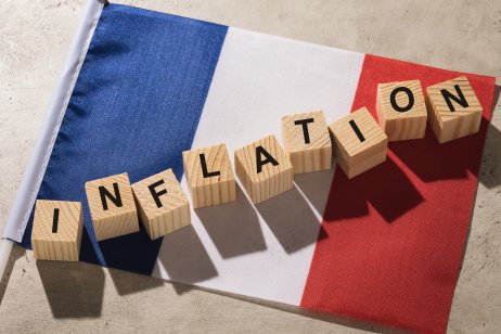 Flag of France and wooden cubes with text, concept on the theme of inflation in the country