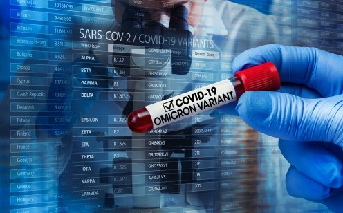 A picture of a researcher with a blood sample of the new variant of the Covid-19 Omicron B.1.1.529 and generic data of covid-19 Coronavirus Mutations. Doctor in analysis lab holding sample of new strain of covid Omicron