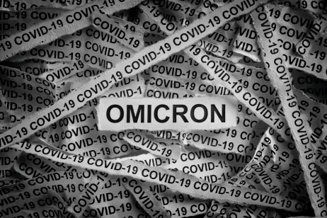 A picture of strips of newspaper with the words Omicron and Covid-19 typed on them