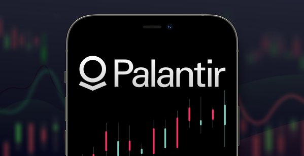 NY - 26 November 2021: Palantir logo in a smartphone with a series of stock charts on the background.