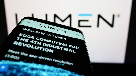 Mobile phone with website of US telecom company Lumen Technologies Inc. on screen in front of business logo.