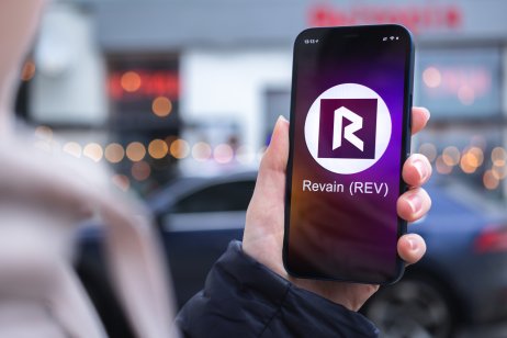 Revain (REV) logo on a smartphone screen