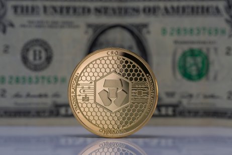 Cronos coin with US dollar background