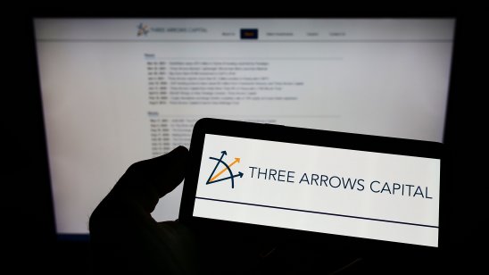 Person holding smartphone with logo of Three Arrows Capital