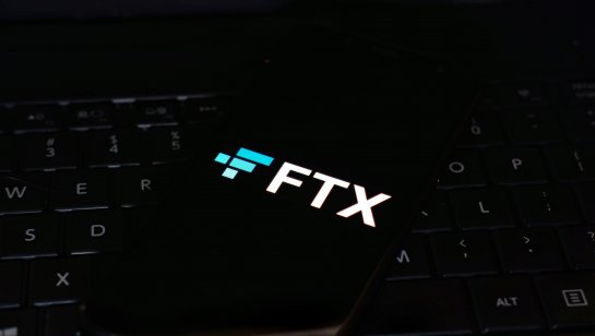The FTX name and logo is displayed on a smartphone