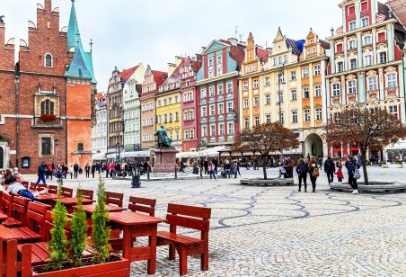 People walking, resting on the famous, old market square in Wroclaw, Poland
