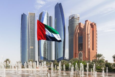 tihad tower ensemble in Abu Dhabi with fountains and flag in the foreground