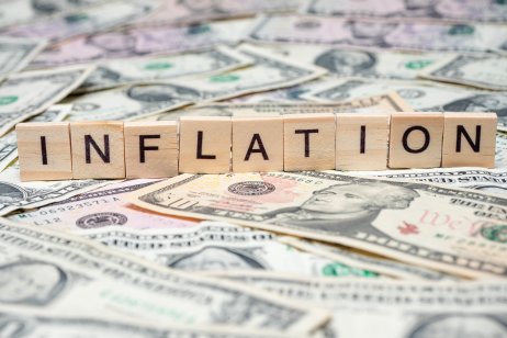 The word ‘inflation’ spelt out in Scrabble letters on top of US dollar notes 