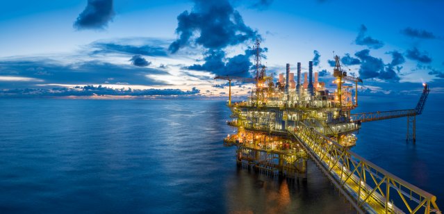 An oil and gas offshore production platform in twilight