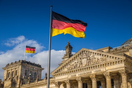 German flags waving in the wind in the famous Reichstag building, the seat of the German Parliament