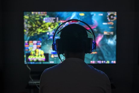 A gamer playing video game wearing headphones