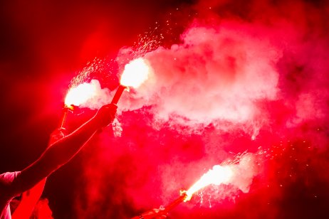 Football fans burning flares during a match 