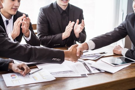 Employees shaking hands to make a business deal
