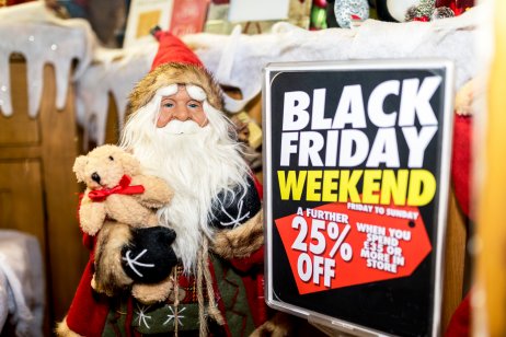 Santa Claus next to Black Friday sale sign in the UK