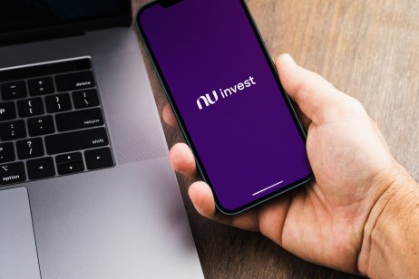 The Nubank logo appears on a cell-phone screen