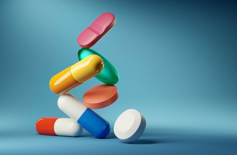 Colorful pills falling out of a bottle