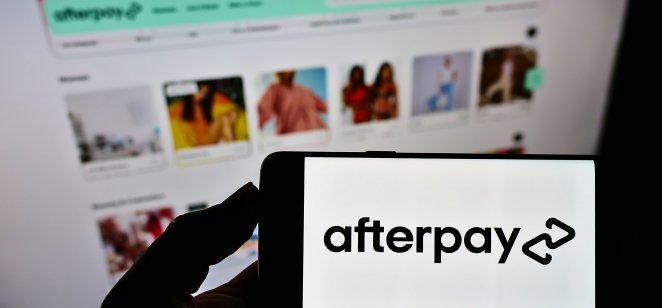 Afterpay logo on a smartphone with a background of a web page