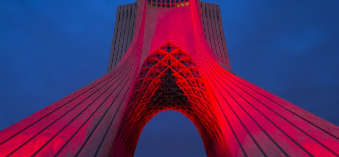 The Azadi Tower in Tehran, Iran at dusk.