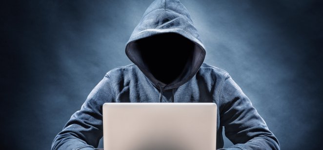 Man in hoodie sitting at laptop