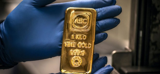 A worker displays a one kilogram gold bullion bar at the ABC Refinery in Sydney