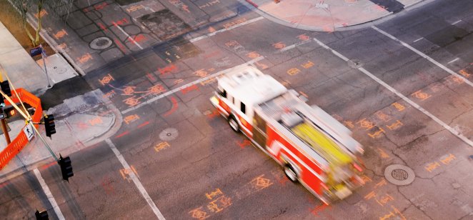 Does the fire truck have to put the brake on the US dollar? High Angle View Of Traffic Downtown – Fire trucks at cross road