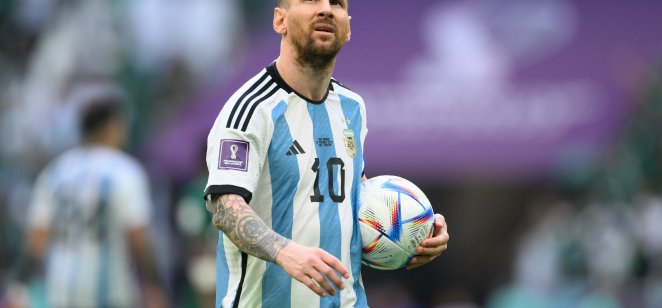 Lionel Messi of Argentina holds a football during the World Cup group C match between Argentina and Saudi Arabia