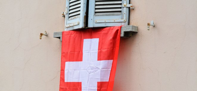 Red & white Swiss flag draped under window