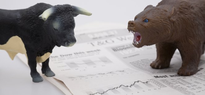 bull vs bear on top of a stock market newspaper 