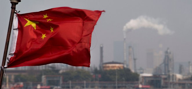 Chinese flag fluttering in front of the Shanghai Gaoqiao Company Refinery 