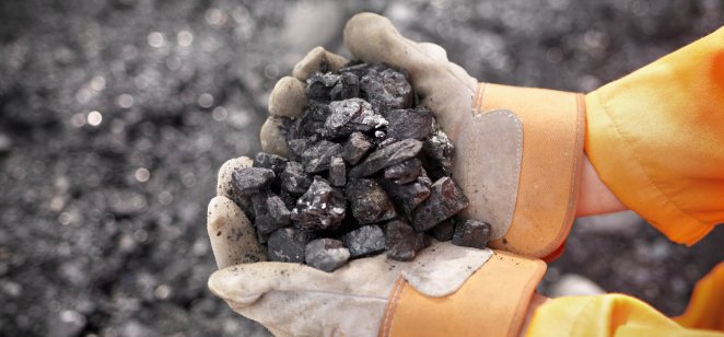 Coal worker with handful of coal