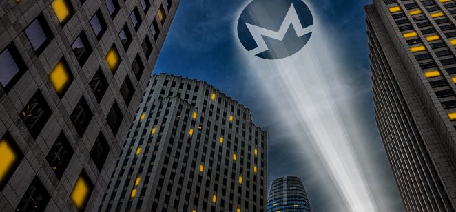  Monero cryptocurrency logo light beam projecting on a dark sky between skyscrapers