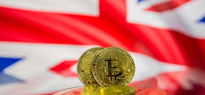 Bitcoin Bitcoin coins in front of a UK flag