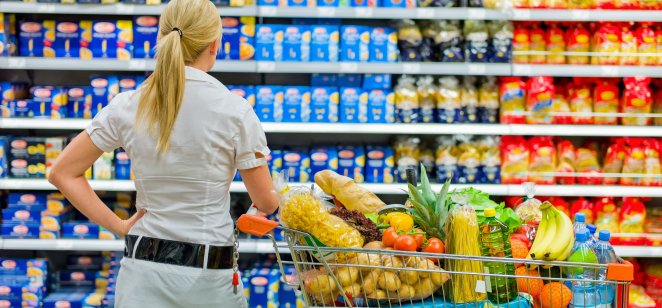 A shopper in a supermarket makes purchasing choices