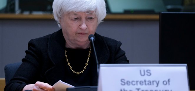 Janet Yellen, US Treasury Secretary, looks at her notes in front of a microphone 