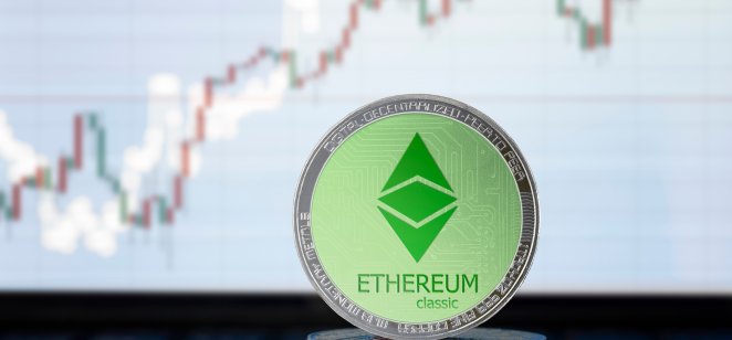Ethereum classic (ETC) coin on top of a stack of ETC tokens with price chart behind it