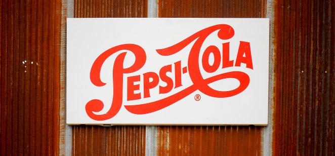 Photo of vintage Pepsi logo against a wall 