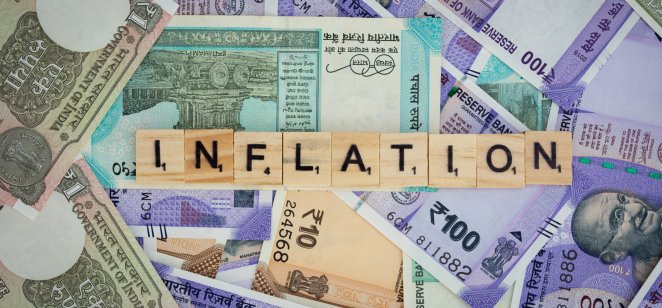 Concept of Inflation word on Indian currency Notes.