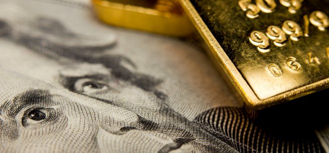 Close-up of a $20 banknote and gold bullion