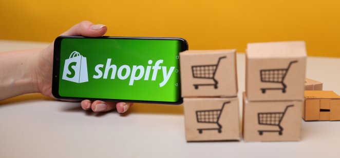 Shopify stock forecast: Can the stock recover? Shopify on the phone display.