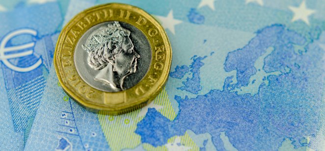 GBP coin on a background of Euro notes 