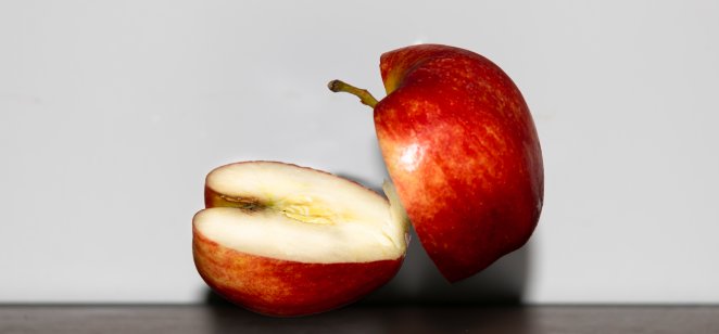 An apple divided into two halves.