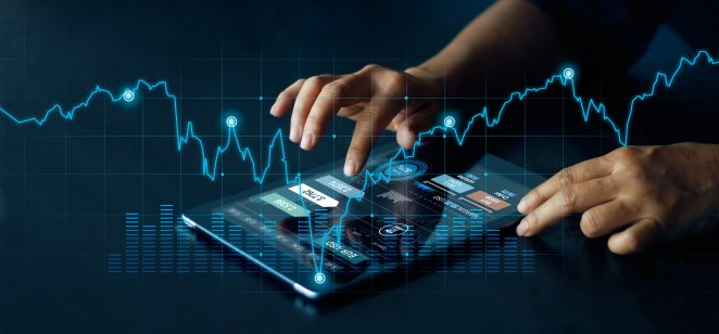 Lucky block (LBLOCK) A man's hands work a computer tablet, which is overlaid with a trading chart