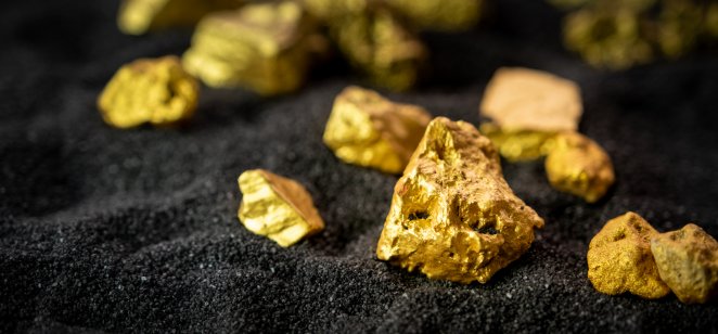 Nuggets of gold ore lying on a black background