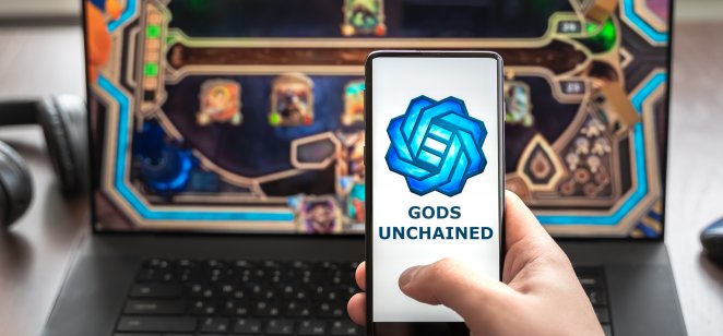 Russia Moscow 30.05.2021.Logo, screenshot of blockchain nft ethereum cryptocurrency game Unchained gods in laptop.mobile phone. Man playing,collecting cards,crypto coins. Digital money. Lands,heroes.