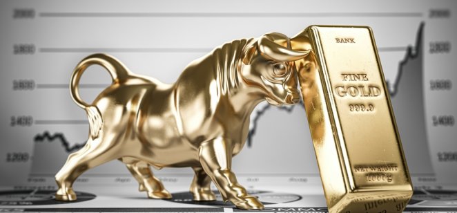 Golden ingot and bull on graph. Bull market trend in gold.