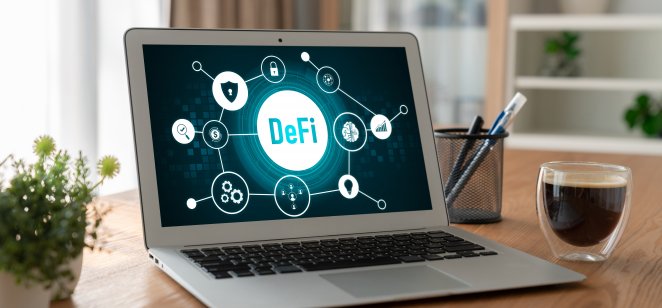 A laptop features an illustration explaining decentralised finance (DeFI)