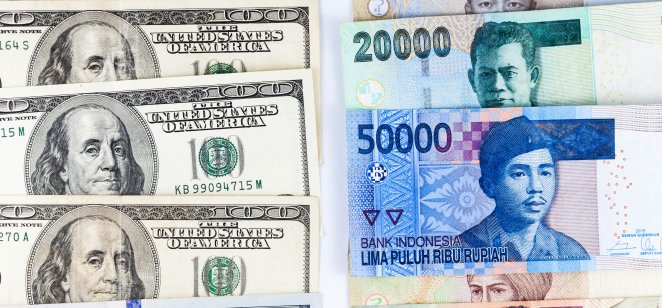 Close up view of US Dollar and Indonesia Rupiah indicating strong currency exchange rate