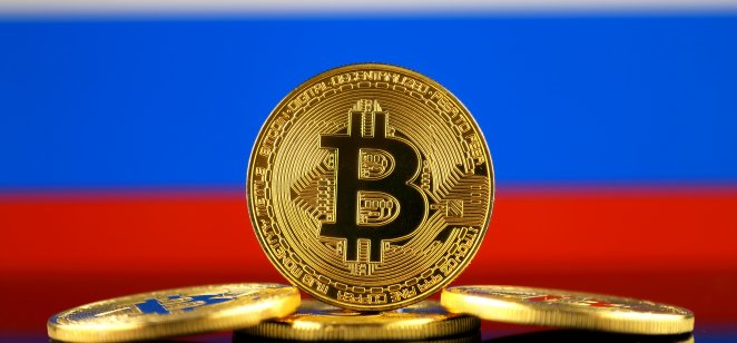 Coin with bitcoin (BTC) logo against flag with Russian background.