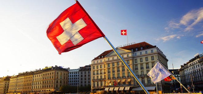 Flag of the Geneva Canton and flag of Switerland in the city center of Geneva on the Mont Blanc Bridge