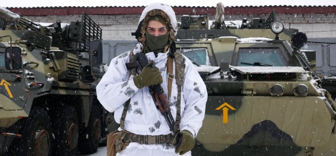 A Russian soldier in front of a tank